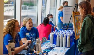 a new student speaking to some orientation leaders