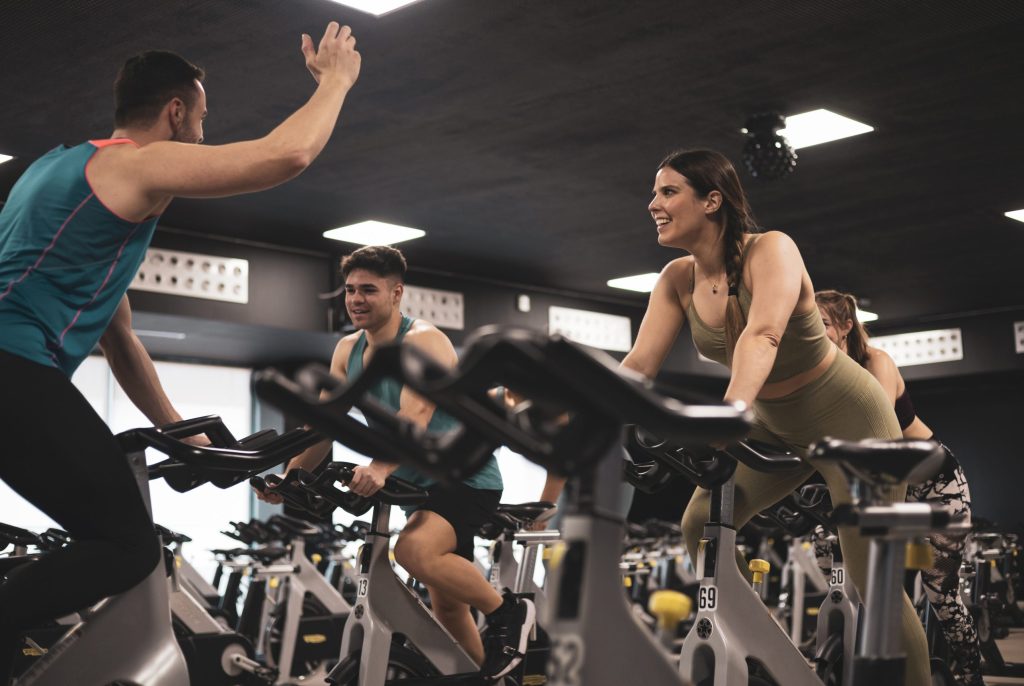 people on exercise bikes in a cycling studio class